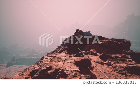 The awe-inspiring beauty of a red stone canyon, adorned with rocks, set against a vast sky backdrop. The awe-inspiring beauty of a red stone canyon, adorned with rocks, set against a vast sky backdrop. 130335015