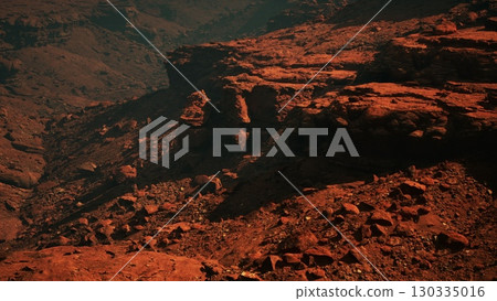 Witness the mesmerizing grandeur of crimson stone canyons harmoniously intertwined with towering mountains, overlooking a serene and magnificent valley. Witness the mesmerizing grandeur of crimson stone canyons harmoniously intertwined with towering mountains, overlooking a serene and magnificent valley. 130335016