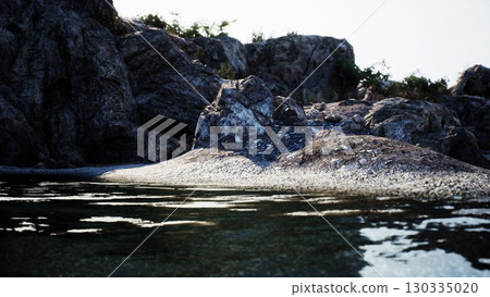 A breathtaking rock formation rises from the tranquil waters, creating a stunning sight on the Spanish coast. A breathtaking rock formation rises from the tranquil waters, creating a stunning sight on the Spanish coast. 130335020