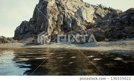 A breathtaking rocky mountain in Spain, overlooking a serene body of water. A breathtaking rocky mountain in Spain, overlooking a serene body of water. 130335022