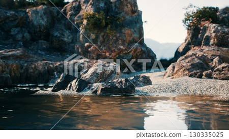 A picturesque body of water enclosed by a formation of large rocks along the South African coast. 130335025