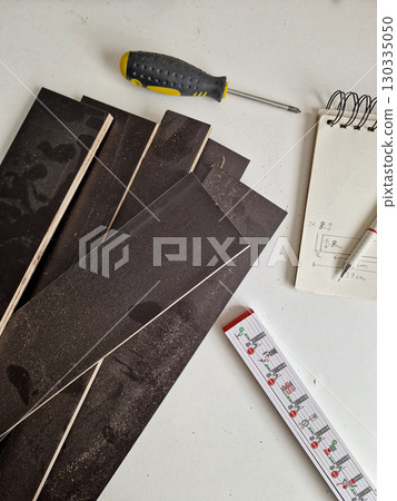 DIY Project Materials: Wooden Boards, Screwdriver, Measuring Tape and Notebook with Sketch 130335050