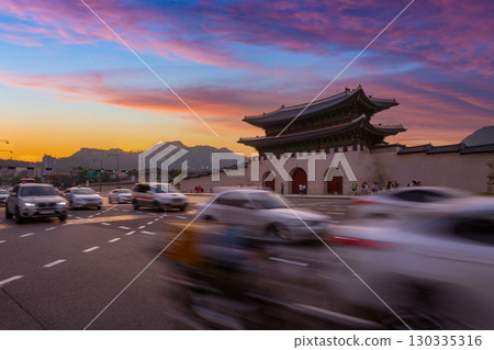Gyeongbokgung Palace at sunset with Traffic is moving in the foreground and gwanghwamun Gate in the background, Seoul, South Korea. 130335316