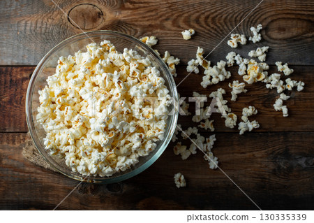 Pop corn on wood color background.Food and snack concepts ideas.Minimal style top view mockup Pop corn on wood color background.Food and snack concepts ideas.Minimal style top view mockup 130335339