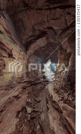 A cave with an abundance of rocks and water, illuminated by rays of light penetrating through the stone walls. A cave with an abundance of rocks and water, illuminated by rays of light penetrating through the stone walls. 130335417