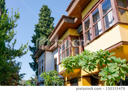 Yellow house with a green tree in front of it Yellow house with a green tree in front of it 130335479