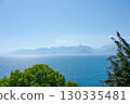Beautiful blue ocean with a mountain range in the background 130335481