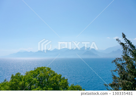Beautiful blue ocean with a mountain range in the background 130335481