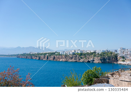 Beautiful blue ocean with a rocky shoreline Beautiful blue ocean with a rocky shoreline 130335484