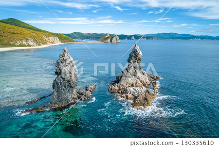 Stunning coastal landscape at sunrise with distinct rock formations and clear ocean waters Stunning coastal landscape at sunrise with distinct rock formations and clear ocean waters 130335610
