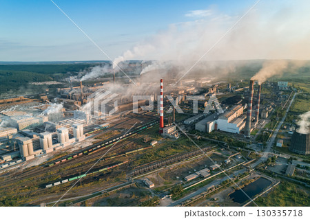 Industrial pollution causes environmental degradation in a large manufacturing facility with smoke and emissions during daytime Industrial pollution causes environmental degradation in a large manufacturing facility with smoke and emissions during daytime 130335718