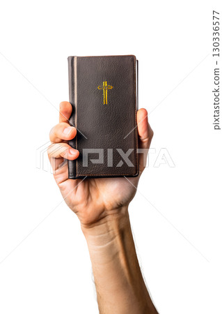 Hand holding holy bible with golden cross on the cover, sacred religious book isolated on transparent background Hand holding holy bible with golden cross on the cover, sacred religious book isolated on transparent background 130336577