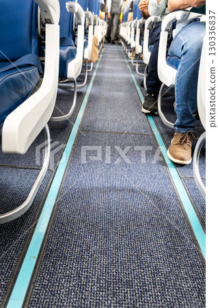 Airplane cabin carpeted floor with reflective and illuminated guide lines for evacuation during emergency 130336837