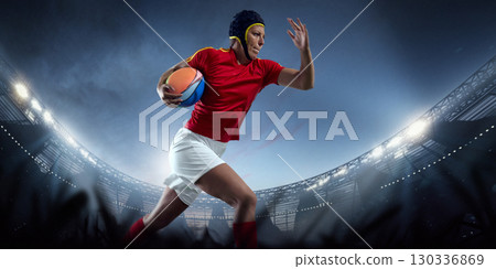 Female rugby player sprinting with ball across illuminated 3D stadium field 130336869
