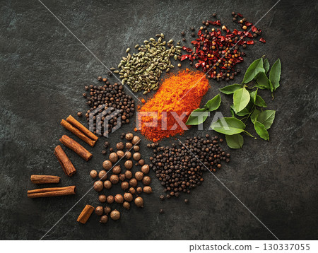 Various Indian spices set against a dark and rustic background. 130337055