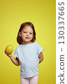 cute Caucasian little child girl holding lemon on yellow background 130337665