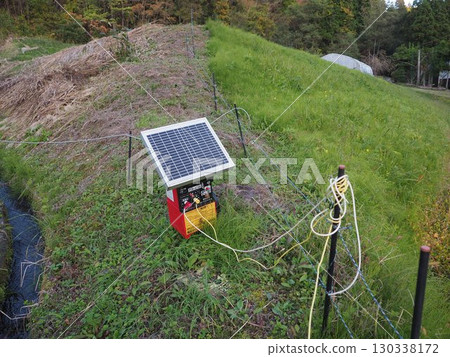 Electric fences installed in rice paddies to protect against pest damage Electric fences installed in rice paddies to protect against pest damage 130338172