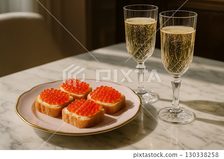 Toast with caviar and champagne flutes, a luxury appetizer 130338258