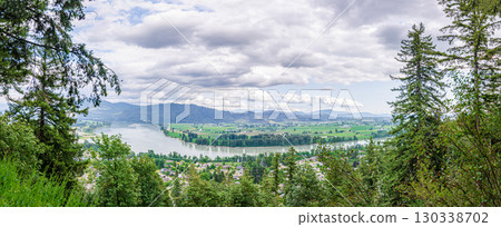 View of the Mission town with Fraser River, lush green valley and the mountains in the background - Fraser Valley, BC, Canada 130338702