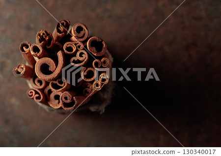 Cinnamon sticks on a rusty background. Cinnamon sticks on a rusty background. 130340017