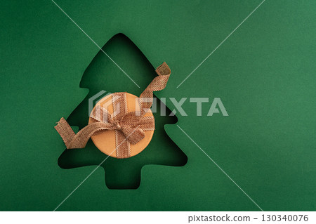 Christmas Gift Box with Red Ribbon in Tree Cutout Design Christmas Gift Box with Red Ribbon in Tree Cutout Design 130340076