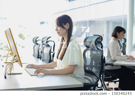 Woman working with a personal computer 130340245