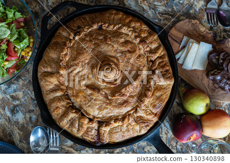 Tatar balesh pie, homemade traditional tatar cuisine, rustic potato meat pie Tatar balesh pie, homemade traditional tatar cuisine, rustic potato meat pie 130340898