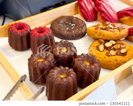 Variety of baked goods including canale, cookies, and pastries. Sweet flavors, bakery tradition, and indulgent treats. 130341111
