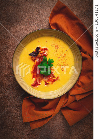 Pumpkin cream soup, curry, fried bacon, bruschetta chips,micro-greens, top view, no people, 130341171