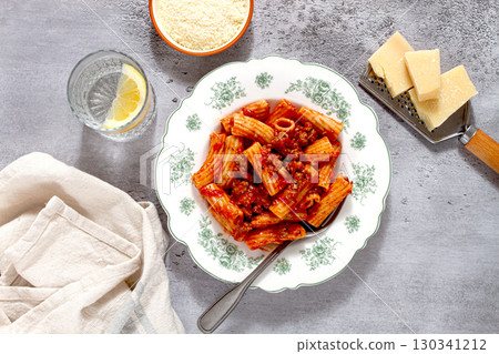 Rigatoni pasta with meat sauce and parmesan cheese on a light table, top view, homemade, no people, Rigatoni pasta with meat sauce and parmesan cheese on a light table, top view, homemade, no people, 130341212