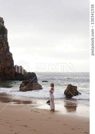 In Solitude by the Ocean A Woman Walking Alone Peacefully on the Beautiful Scenic Beachside In Solitude by the Ocean A Woman Walking Alone Peacefully on the Beautiful Scenic Beachside 130341556