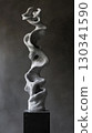 Surreal twisted clay sculpture with elongated distorted limbs on black pedestal 130341590