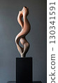 Surreal twisted clay sculpture with elongated distorted limbs on black pedestal 130341591