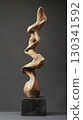 Surreal twisted clay sculpture with elongated distorted limbs on black pedestal 130341592