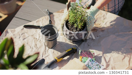 Preparation for transplanting a houseplant using extended clay, soil, shovel, rake and flowerpot. Home gardening. Hobbies and leisure concept. Preparation for transplanting a houseplant using extended clay, soil, shovel, rake and flowerpot. Home gardening. Hobbies and leisure concept. 130341731