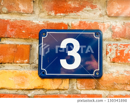 Number three sign on brick wall. Address identification and urban navigation element in residential exterior. Number three sign on brick wall. Address identification and urban navigation element in residential exterior. 130341898