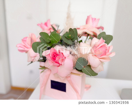 Pink rose bouquet in decorative box. Romance, celebration, and floral beauty for special occasions and gifts. Pink rose bouquet in decorative box. Romance, celebration, and floral beauty for special occasions and gifts. 130341936