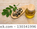 Moringa Oil and Seeds on wooden background 130341996