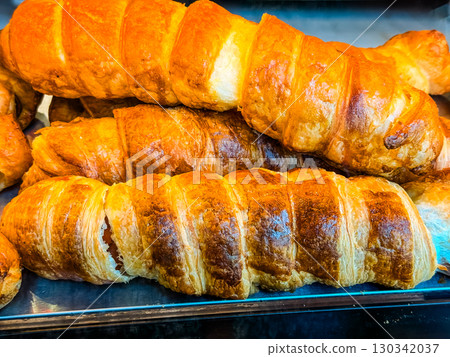 Fresh croissants with golden flaky crust. French bakery, breakfast and pastry indulgence. 130342037