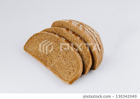 Sliced rye bread loaf isolated on white background, healthy whole grain bakery product Sliced rye bread loaf isolated on white background, healthy whole grain bakery product 130342049