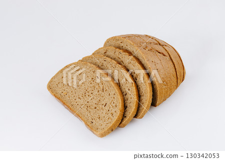 Sliced rye bread loaf isolated on white background, healthy whole grain bakery product Sliced rye bread loaf isolated on white background, healthy whole grain bakery product 130342053