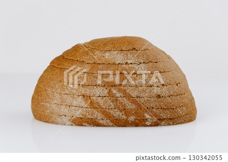 Sliced whole grain bread loaf on white background, rustic and healthy bakery product 130342055