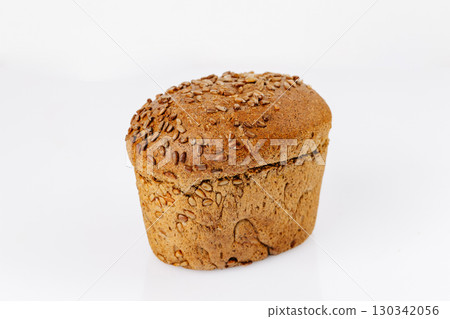 Whole grain bread loaf with sunflower seeds on white background, healthy bakery product Whole grain bread loaf with sunflower seeds on white background, healthy bakery product 130342056