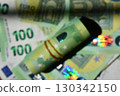 Defocused euro rolled banknote with blurry background showcasing various euro notes in vibrant colors 130342150