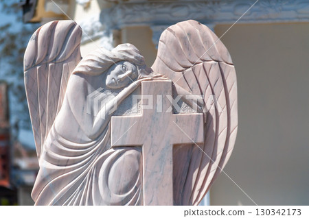 A statue watching over a grave 130342173