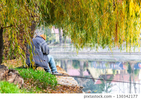 Man fishing on the riverbank Man fishing on the riverbank 130342177