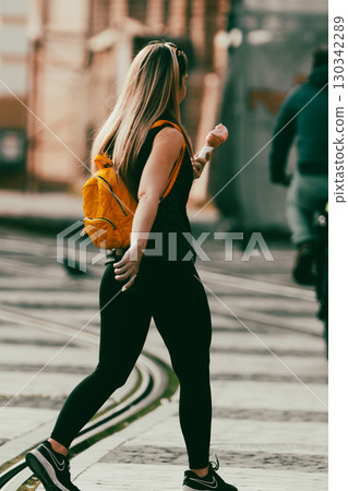 Woman walking on the street 130342289