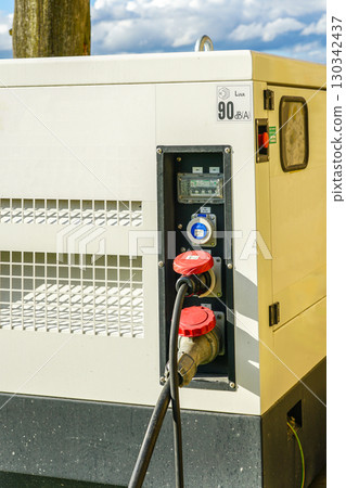 Close-up of diesel generator control panel with power sockets and cables for electricity supply Close-up of diesel generator control panel with power sockets and cables for electricity supply 130342437