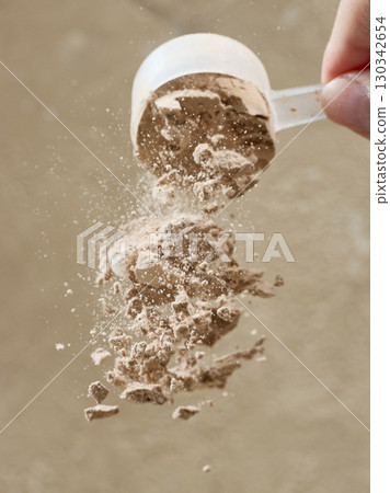 protein powder spills from measure scoop. whey sports nutrition. dry mixture protein powder spills from measure scoop. whey sports nutrition. dry mixture 130342654