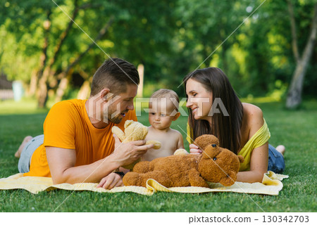 Family Sharing Joyful Moment Outdoors With Teddy Bears Family Sharing Joyful Moment Outdoors With Teddy Bears 130342703
